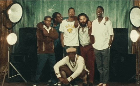 a group of men posing for a picture with one wearing a shirt that says brew