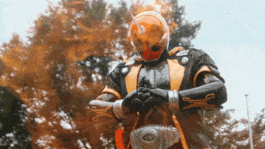a man in a superhero costume with a helmet that looks like a fireball