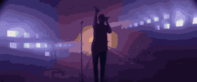a man singing into a microphone with a purple background