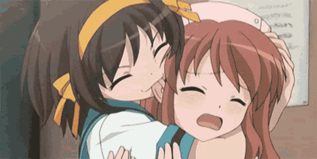 two anime girls are hugging each other in front of a whiteboard