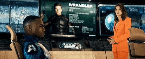 a man is sitting in front of a screen that says wrangler on it