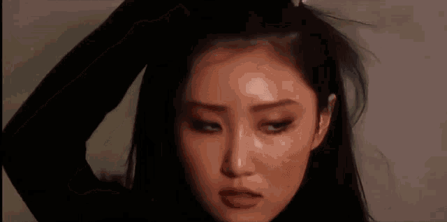 a pixelated image of a woman 's face with a blurred background