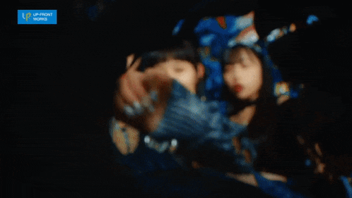 three asian women are posing for a picture with a blue sign that says up front works