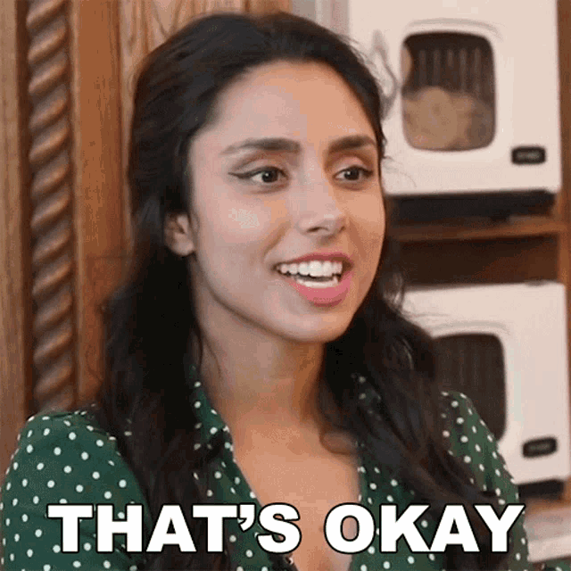 a woman says that 's okay in front of a microwave