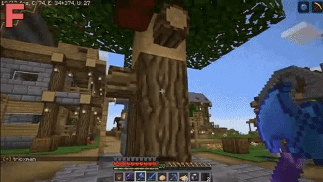 a screenshot of a video game called minecraft shows a tree with an apple on it