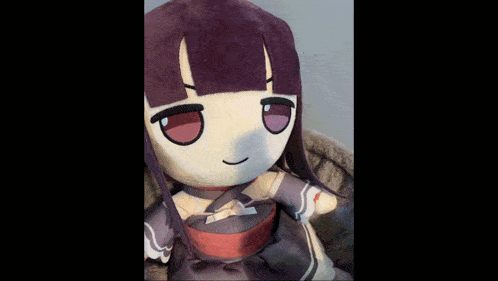a stuffed doll with purple hair is drinking from a bottle