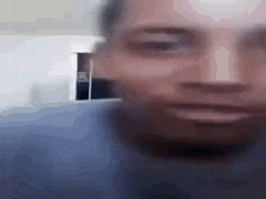 a blurry picture of a man 's face with his eyes closed and his mouth open .