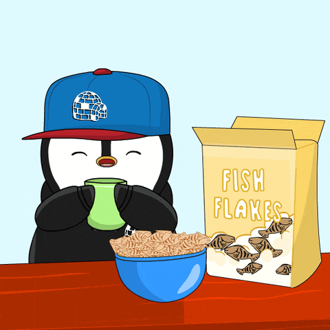 a box of fish flakes sits next to a bowl of cereal