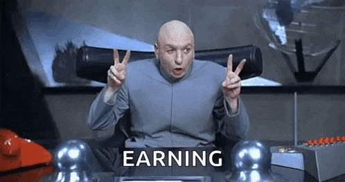 dr. evil is giving a peace sign while sitting at a desk in front of a sign that says earning .