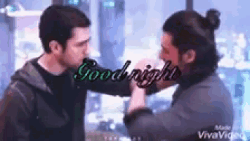 two men are kissing each other and the words `` goodnight '' are written on the bottom .