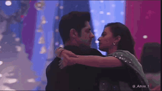 a man and a woman are hugging and kissing each other