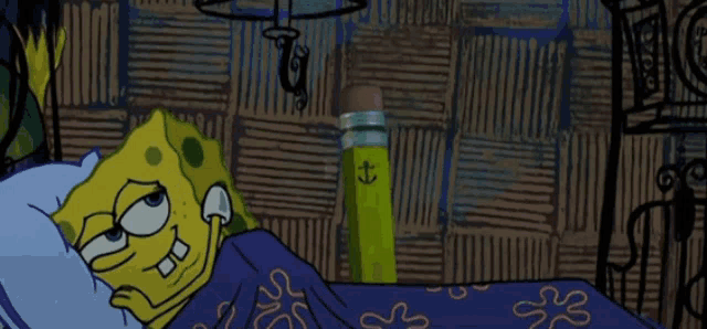 a cartoon of spongebob laying on a bed next to a pencil