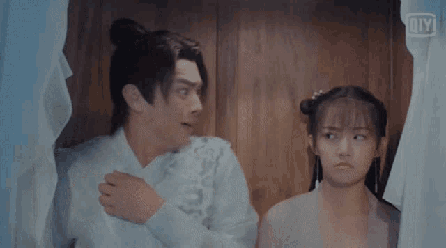 a man and a woman standing next to each other in a room .