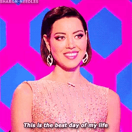 a woman in a pink dress is smiling and says this is the best day of my life