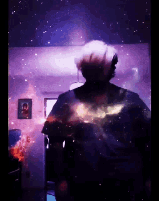 a person is standing in a room with a picture on the wall that says ' a ' on it