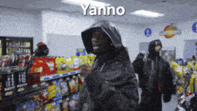 a man in a hooded jacket is dancing in a store with yanno written on the bottom