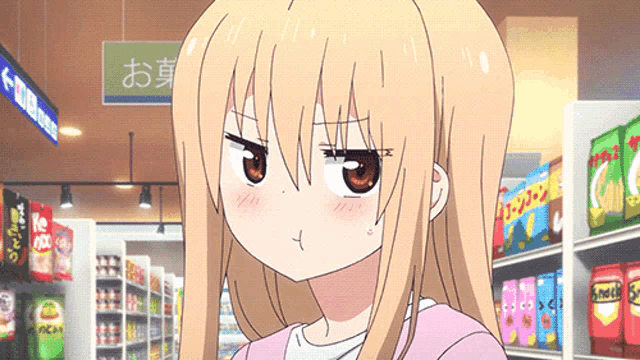 a girl in a pink shirt is making a funny face in a grocery store aisle