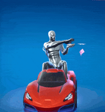 a man is sitting on top of a red sports car with money flying around him