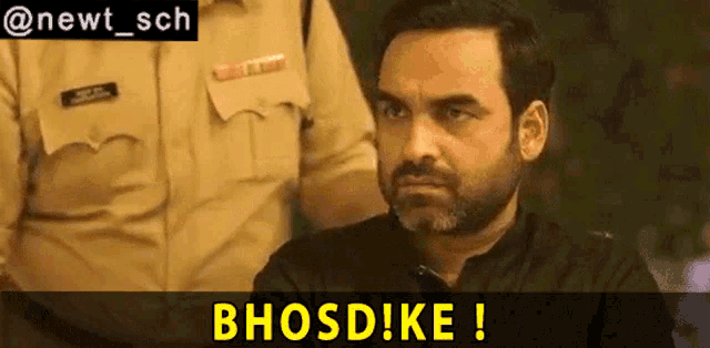 a man with a beard is sitting in front of a police officer and a sign that says bhosdike !