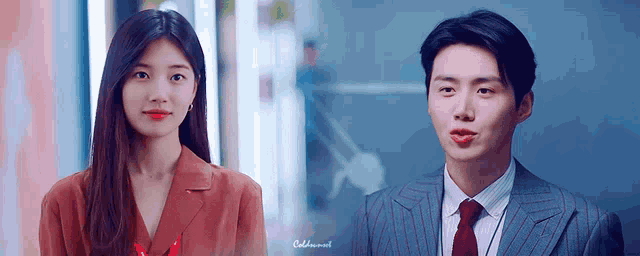 a man and a woman are standing next to each other .