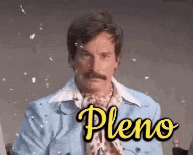 a man with a mustache is wearing a blue jacket with the word pleno written on it