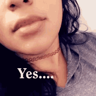a close up of a woman 's face with a choker around her neck that says yes