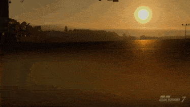 a video game called gran turismo 7 shows a sunset over a race track