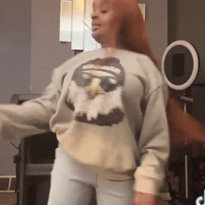 a woman wearing a sweatshirt with a picture of an eagle on it