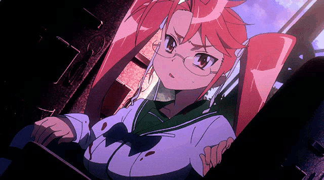 a girl with red hair and glasses is sitting in a dark room