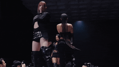 a woman in a black outfit with a belt that says ' 00 ' on it