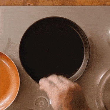 a person is cooking in a frying pan on a stove