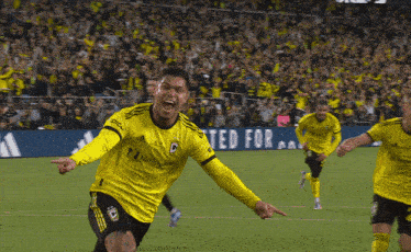 a soccer player wearing a yellow jersey that says ed for