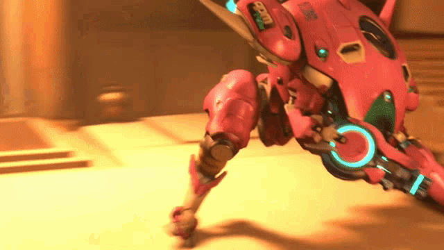 a pink robot with a blue circle around it 's waist has the letters bb on its chest