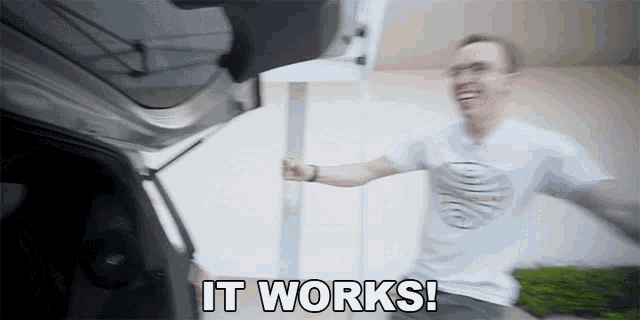 a man in a white shirt is jumping in the air with the words it works behind him