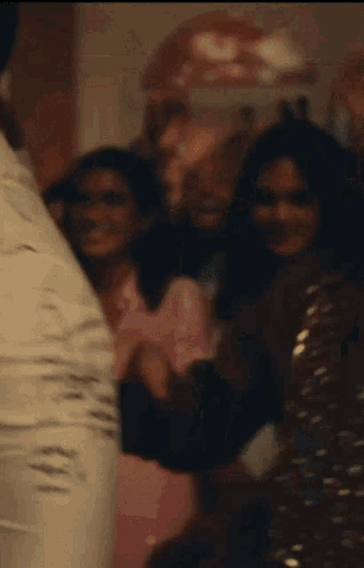 a blurry picture of a group of people dancing in a room