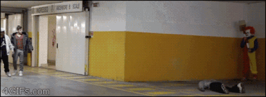a clown is standing in front of a building that says ingresso