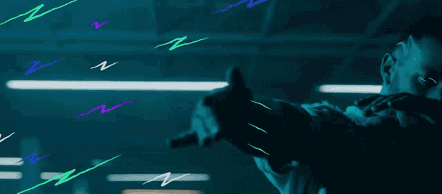 a man in a dark room with neon lights on his head