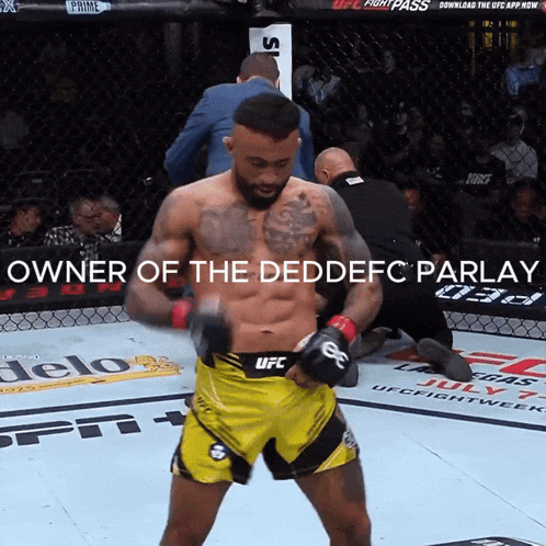 a man in a yellow ufc shorts stands in a boxing ring