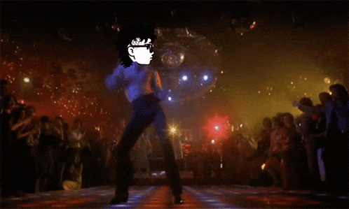a man is dancing in front of a disco ball in a club