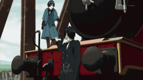 a man in a tuxedo is standing next to another man in a blue coat who is standing on top of a train