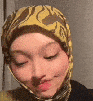 a close up of a woman wearing a yellow scarf on her head
