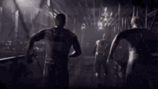 a group of people are running in a dark room holding hands .