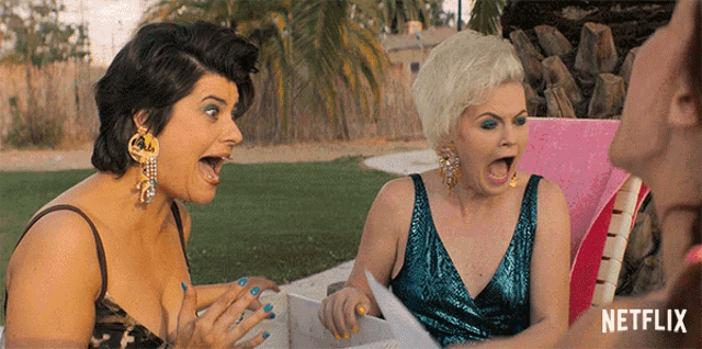 two women are sitting in a chair with a netflix logo behind them