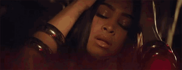 a close up of a woman with her eyes closed wearing bracelets