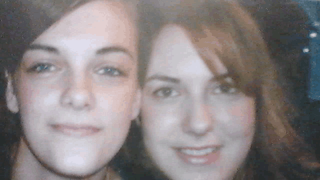 two girls are posing for a picture together and smiling for the camera