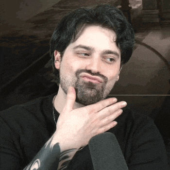 a man with a beard is making a funny face