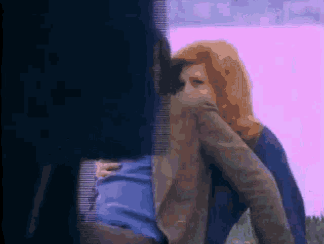 a blurry picture of a woman covering her face