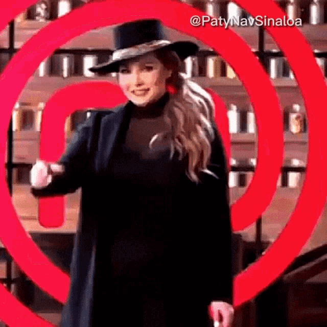 a woman standing in front of a red circle with the name paty nav sinaloa on it