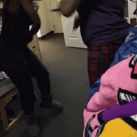 two women are dancing in a room with a bunch of stuffed animals on the floor