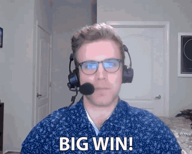 a man wearing headphones and glasses says " big win "